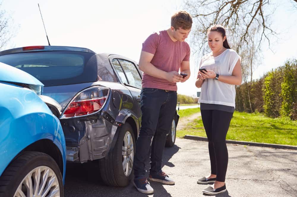 Two people next to auto accident